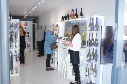 The design consists of glass wine displays and stations lined with tablets where customers can purchase wine to be delivered to their homes.